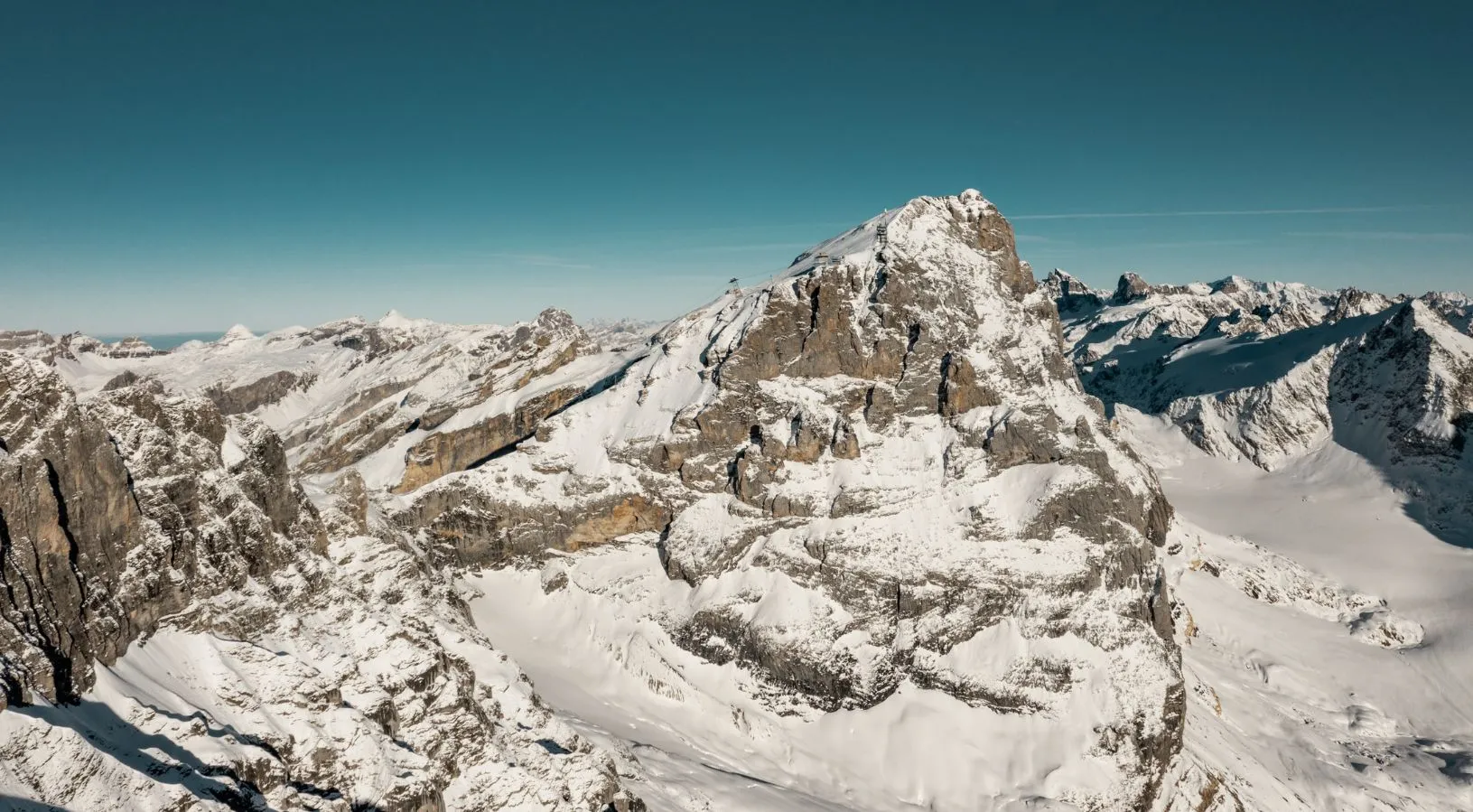 Dramatic snow-covered mountain peaks and glaciers in the Swiss Alps, offering stunning scenery included in Switzerland honeymoon packages for adventure-loving couples.