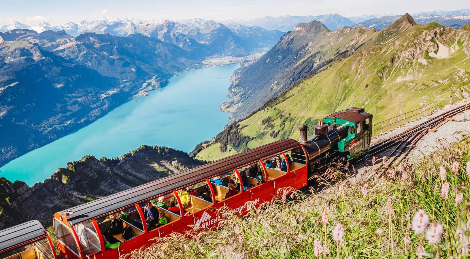 Mountain train overlooking Lake Brienz with panoramic alpine views, a scenic route featured in How the Swiss Travel Pass Works on Trains.