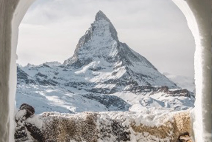 Matterhorn, Switzerland: A snowy mountain range seen through a window