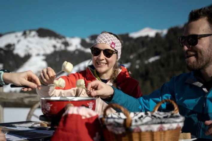 People eating Swiss cuisine in a outdoor set-up