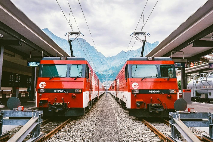 A train station with red trains in Switzerland