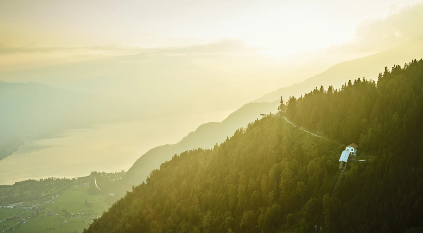 The panoramic view from Harder Kulm, the Top of Interlaken, looking down on the town between Lake Thun and Lake Brienz with the Jungfrau peaks beyond