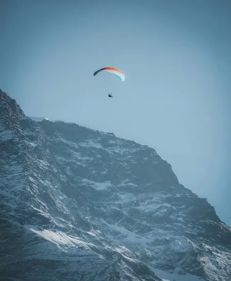 Glide flying over snow-covered mountains of Lauterbrunnen.