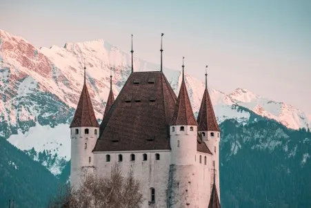 Schloss Thun, a historic castle overlooking the city of Thun in Switzerland, featuring its impressive towers and surrounded by scenic views of the surrounding landscape.